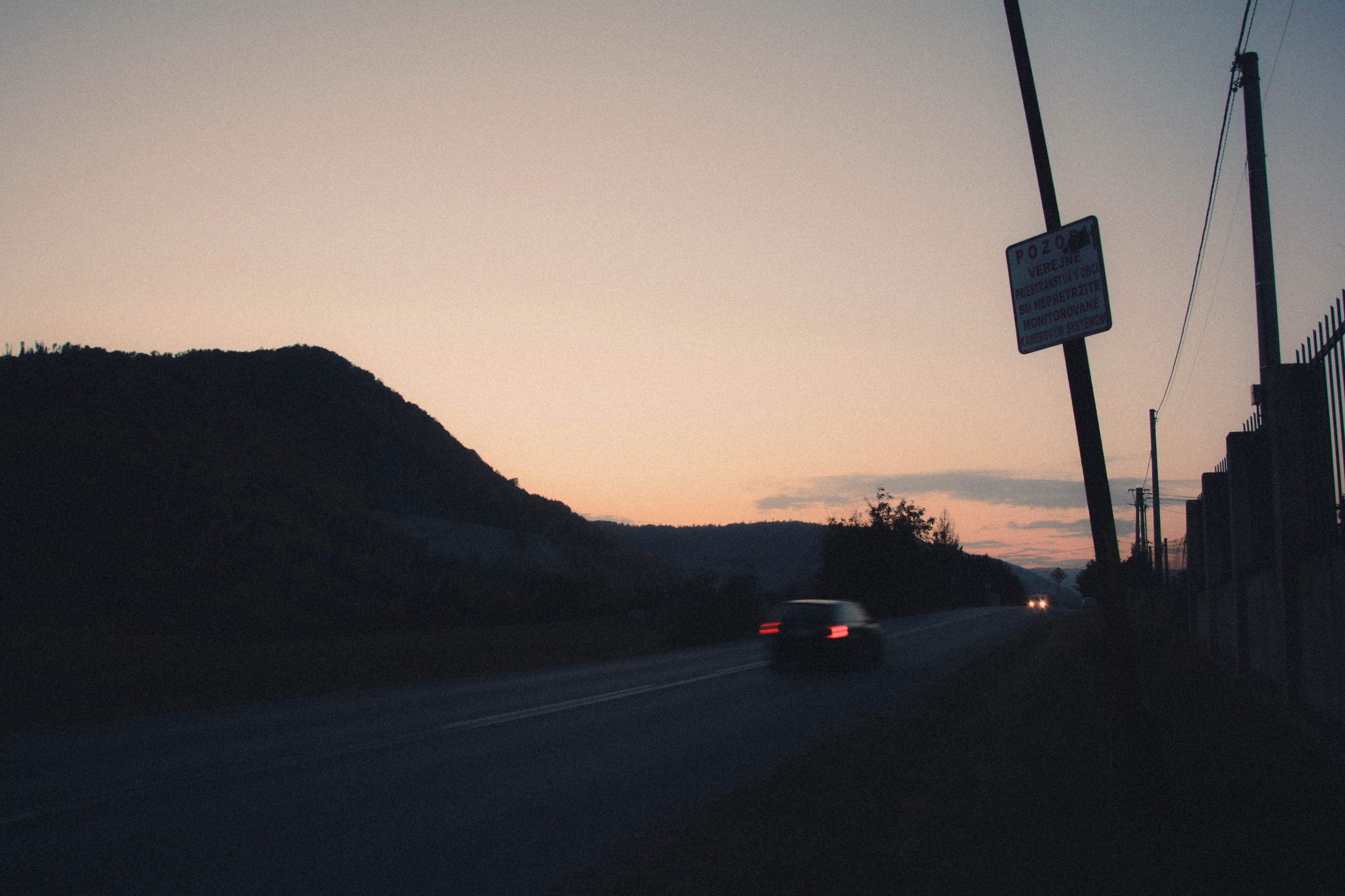 A road and hills beneath the evening sky